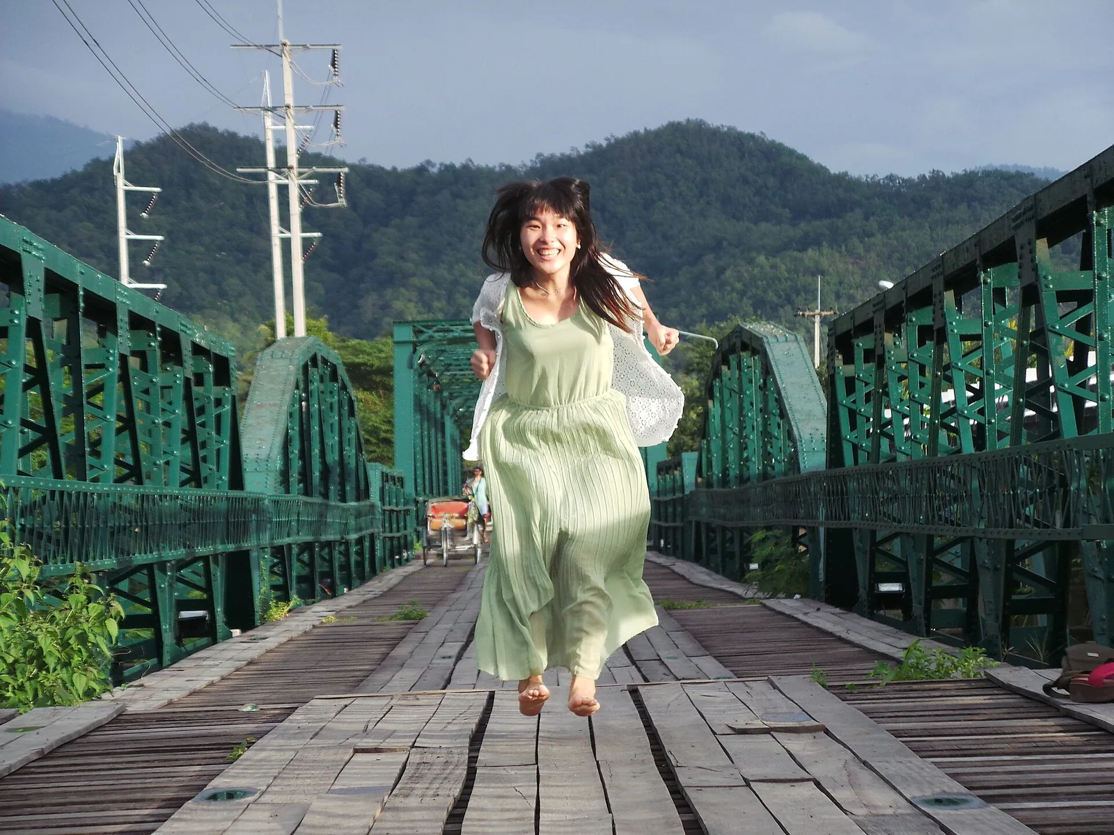 Girl jumping on bridge